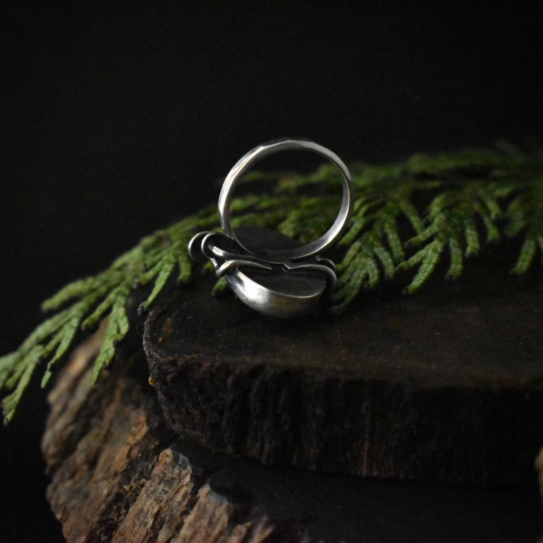 The underside of the Rutilated Quartz Fungal Ring, showing its size 5 1/2 textured sterling silver ring band.