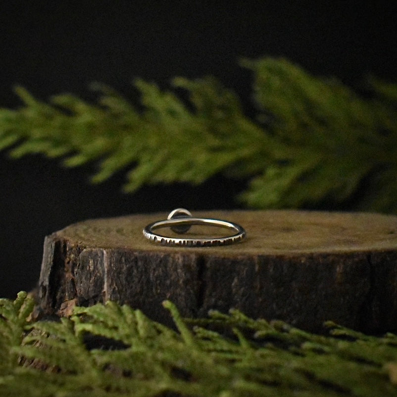 The back of the second Chrysoprase Stacking Ring, showing its size 8 1/2 sterling silver ring band, textured to look like tree bark.