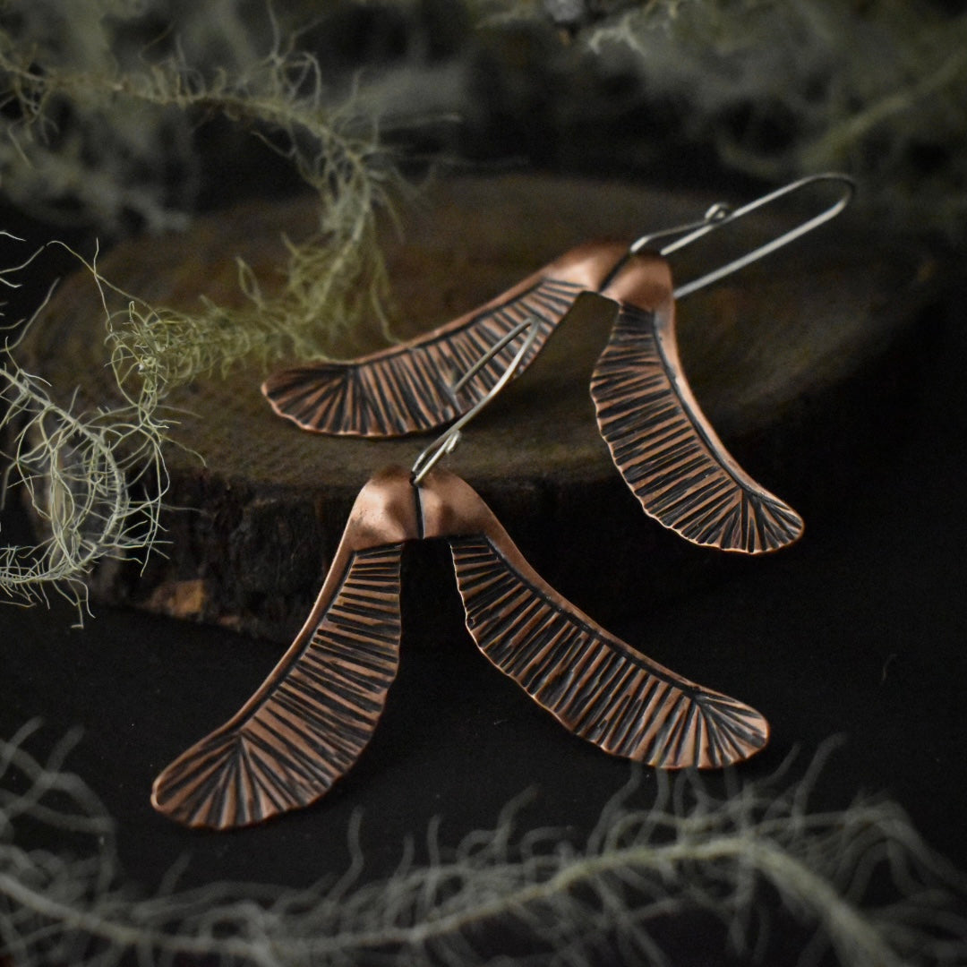 Another look at the Big Helicopter Earrings, showing their sterling silver ear wires.