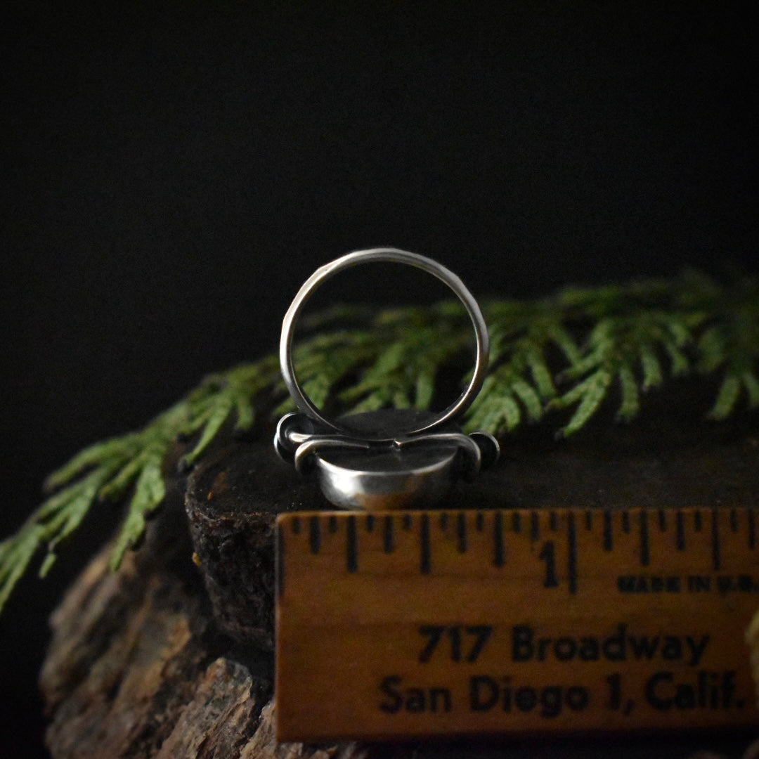 The underside of the Fungal Rutilated Quartz Ring with a ruler for scale, measuring around 3/4 inches wide.