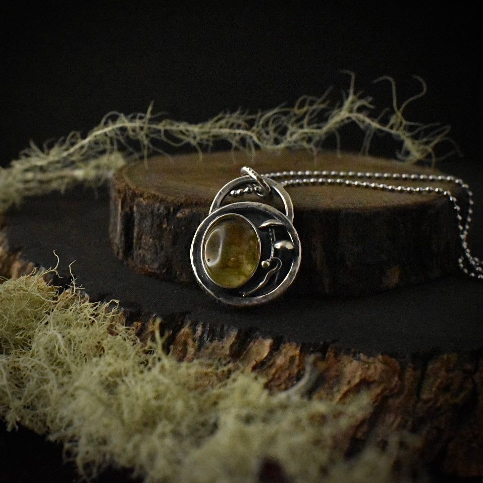 Another look at the Real Moss Shadow Box Forest Floor Pendant, showing its sterling silver elements, formed to look like mushrooms and lichen, and textured bail.