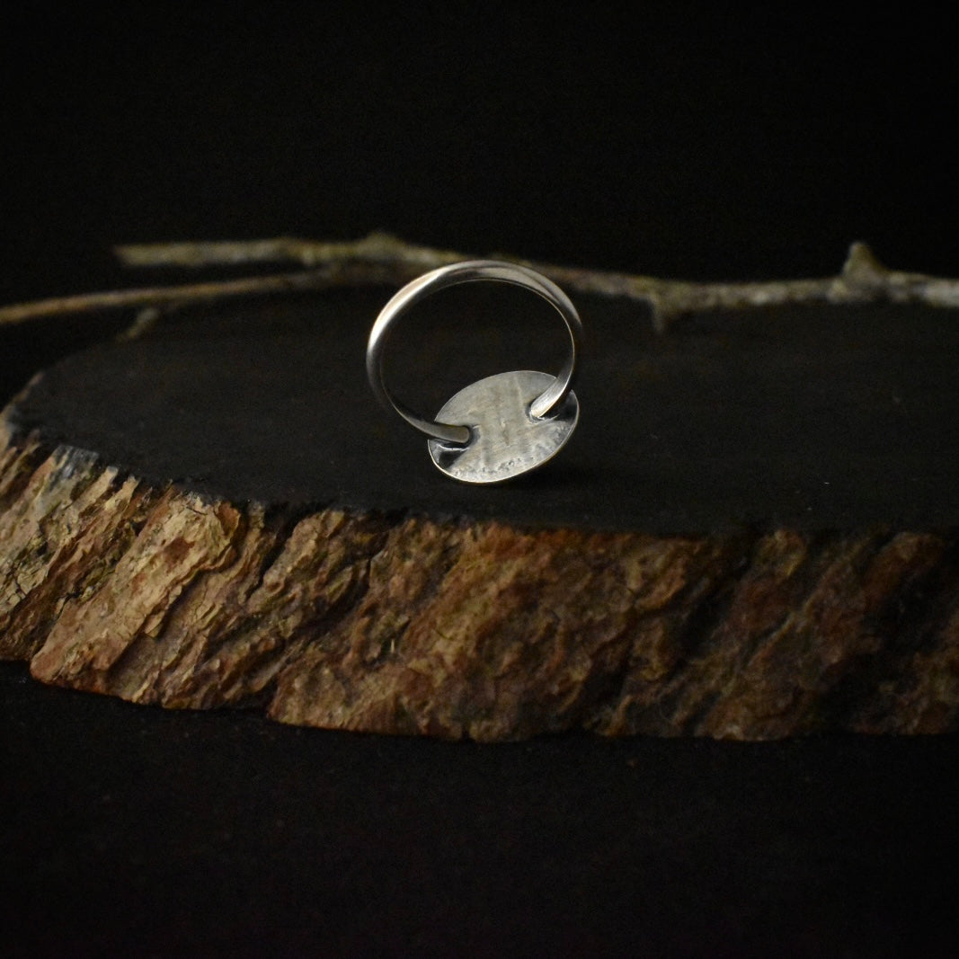 The underside of the Banded Agate Sunrise Ring, showing its size 6 1/2 sterling silver ring band.