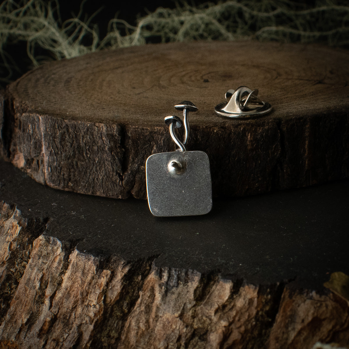 Another look at the back of the Real Lichen Mycena Duo Lapel Pin, showing its nickel pin-back.