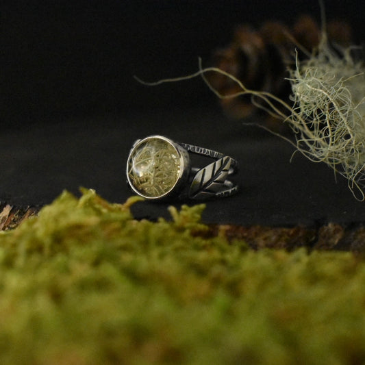 A handmade sterling silver statement ring, with a setting of real lichen preserved in clear resin.