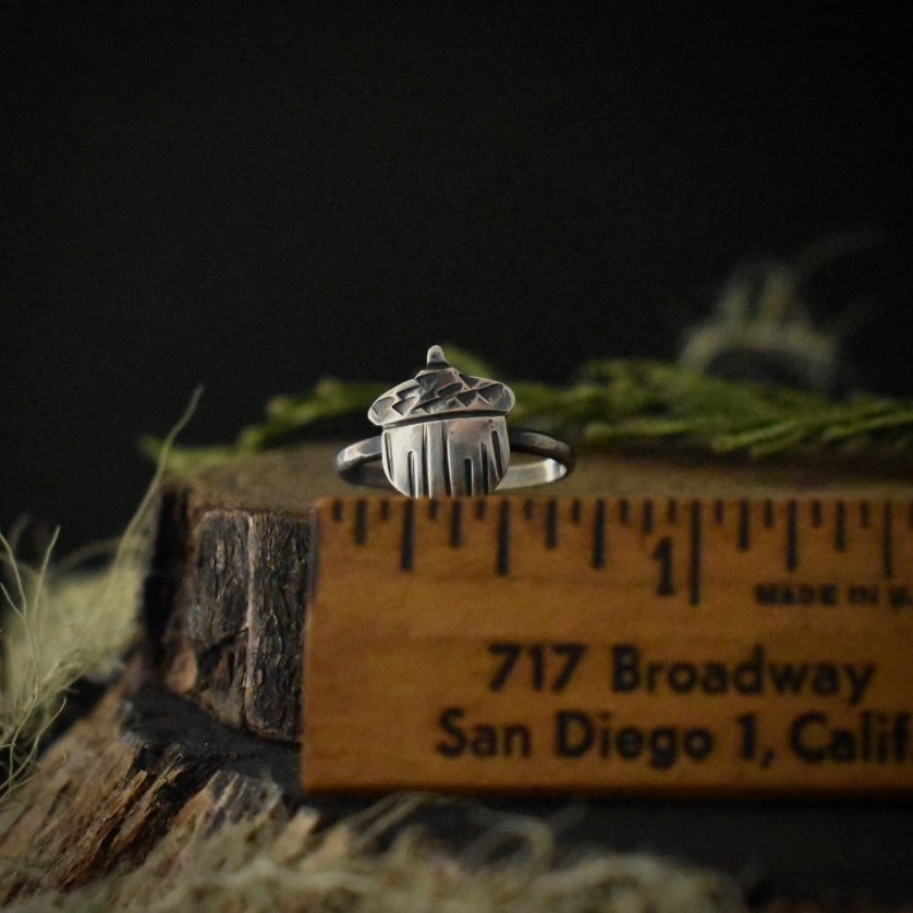 The Acorn Ring with a ruler for scale, measuring around 3/4 inches wide overall.