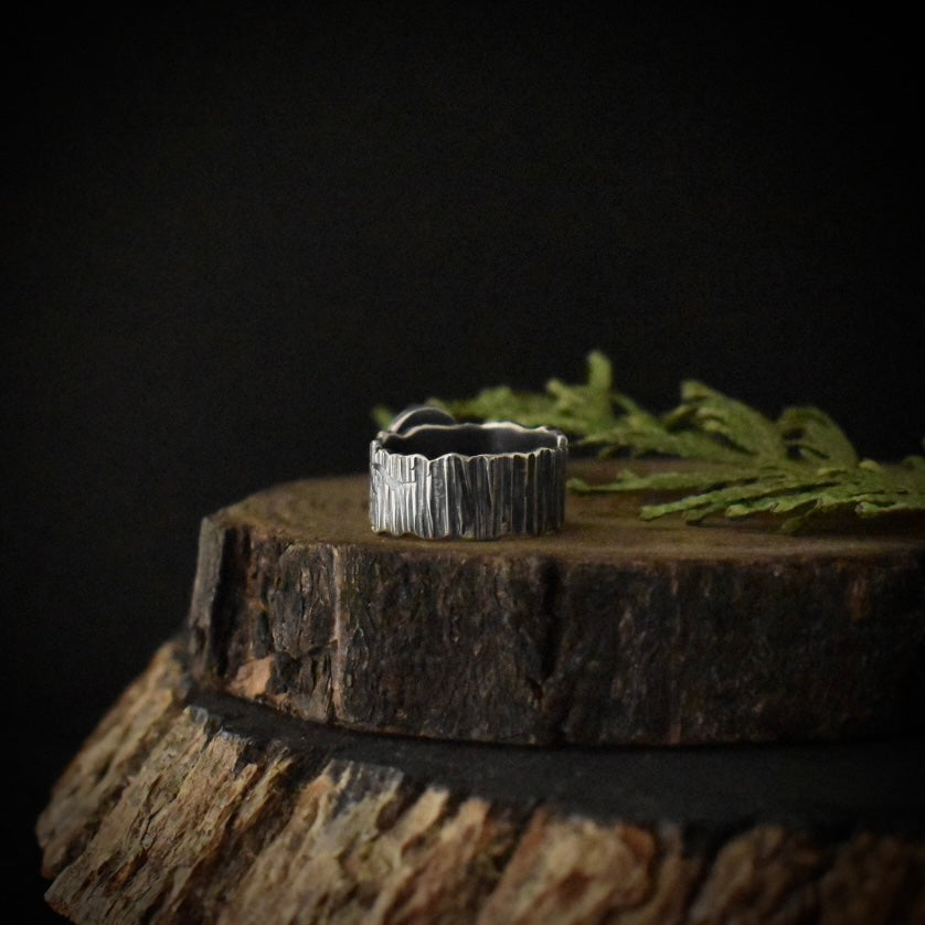 The back of the Tiger’s Eye Wide Bark Band Ring showing its wide, size 5 sterling silver ring band, stamped and textured to look like tree bark.