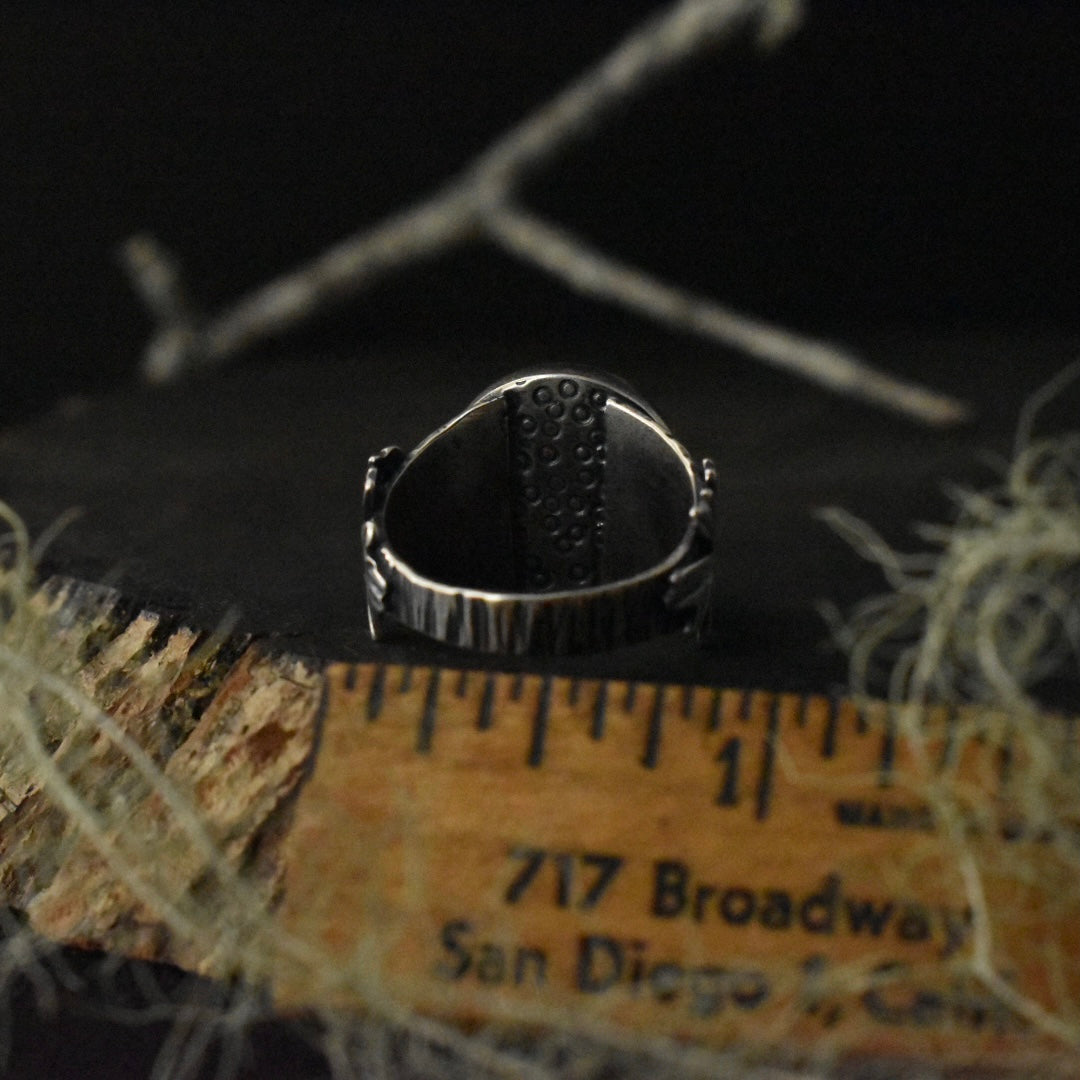 The back of the Real Lichen Double Oak Leaf Ring with a ruler for scale, measuring around 7/8 inches wide overall. 