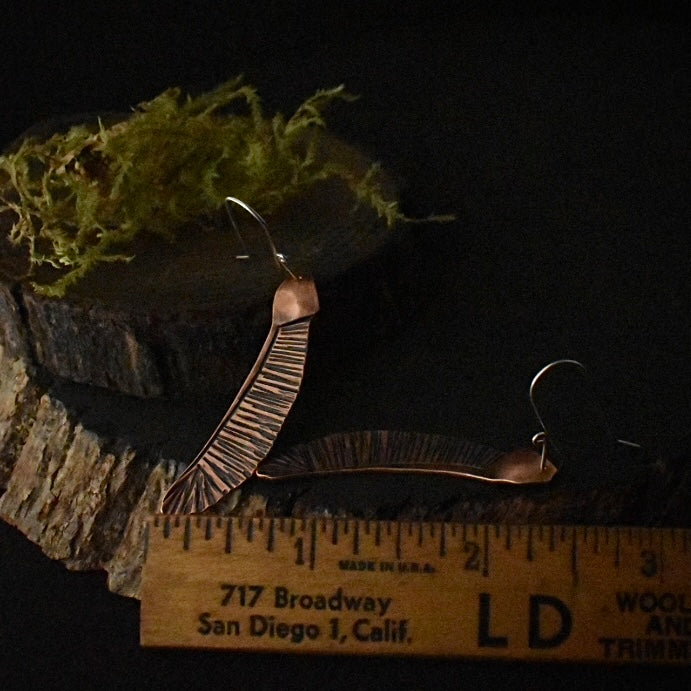 The Single Helicopter Earrings with a ruler for scale, each measuring around 1 3/4 inches long, not including ear wire.