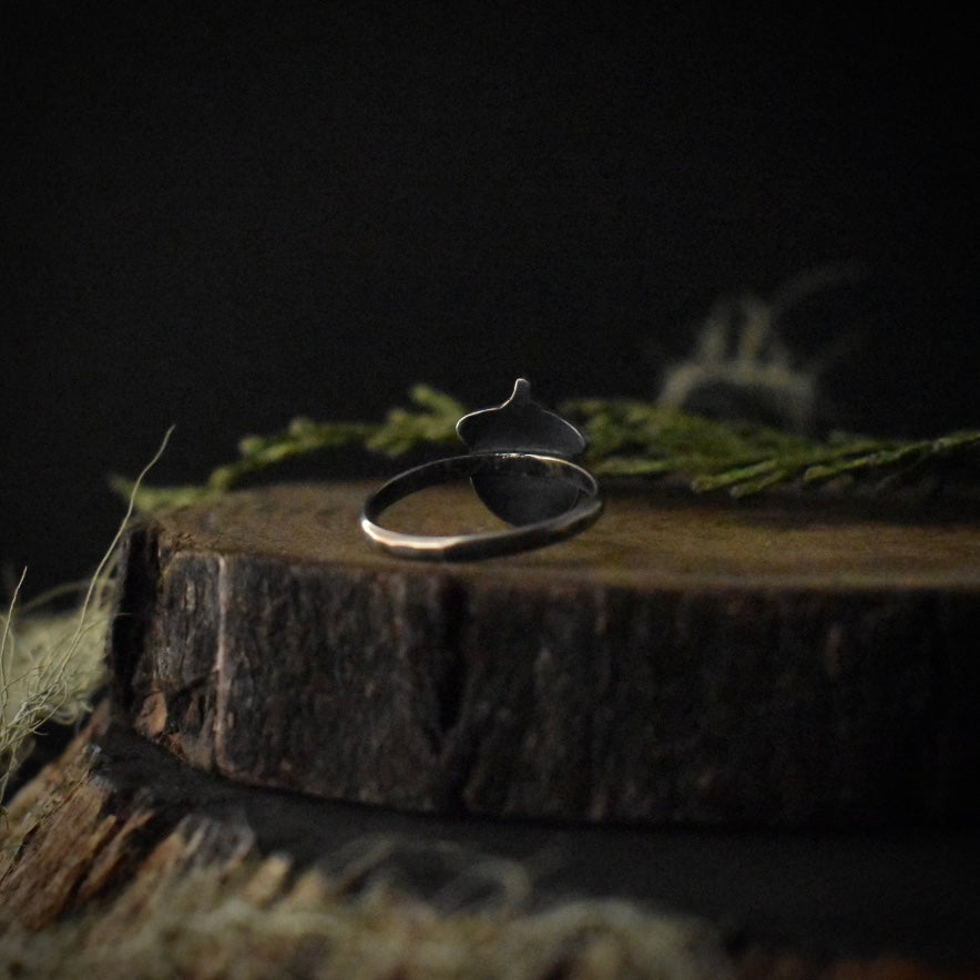 The back of the Acorn Ring, showing its size 5 1/2 sterling silver ring band.