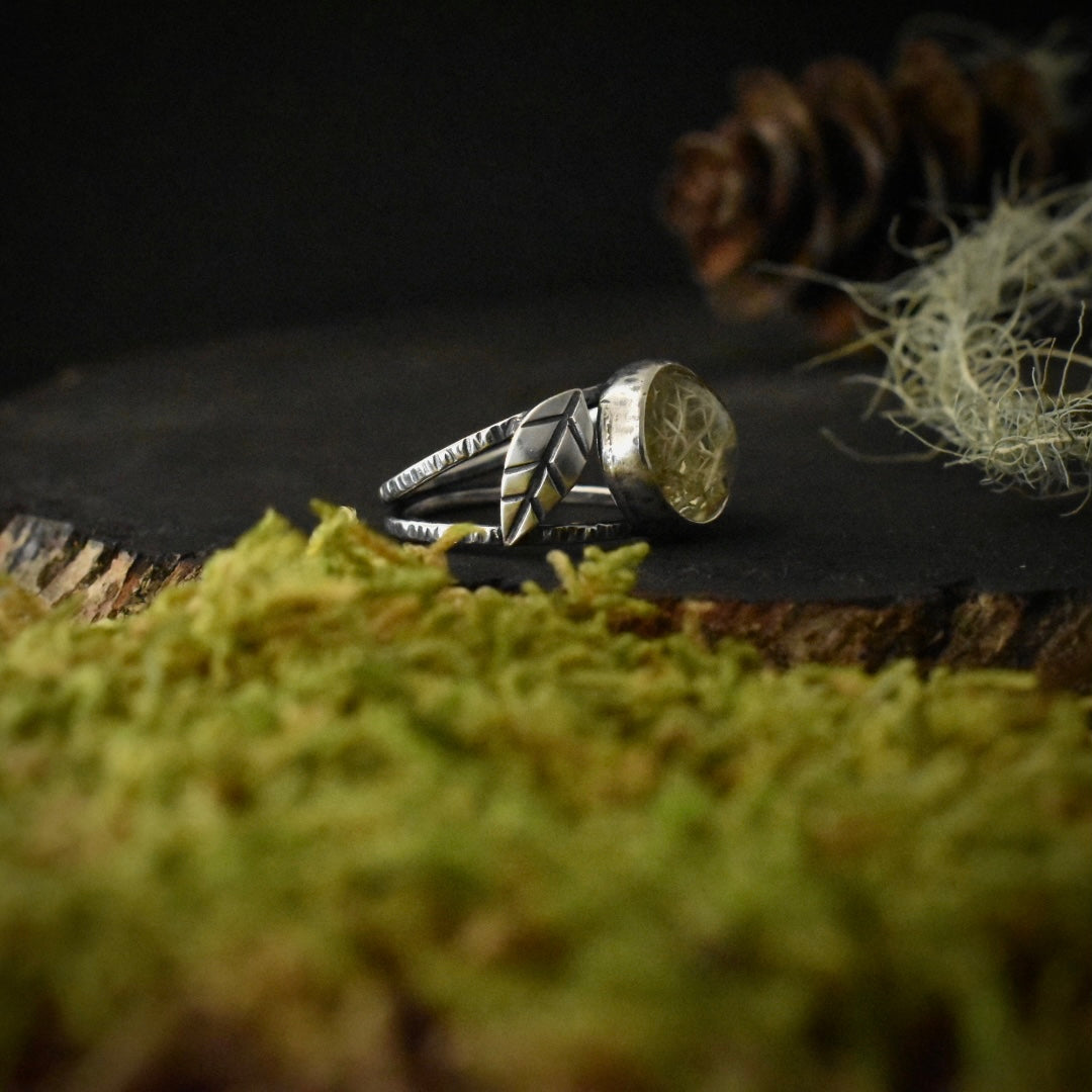 Side view of the Real Lichen Double Leaf Split Band Ring, showing one of its sterling silver elements textured to look like small leaves.
