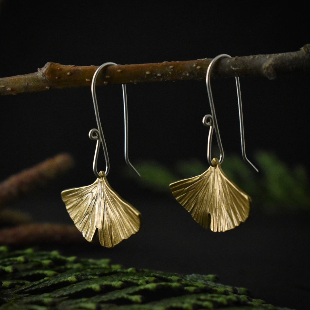 A three-quarter view of the Brass Gingko Leaf Earrings.