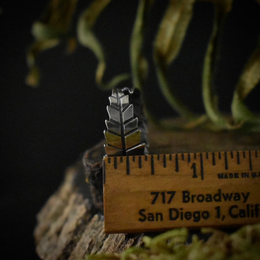 The Cannabis Wrap Ring with a ruler for scale, measuring around 1/2 inches wide.