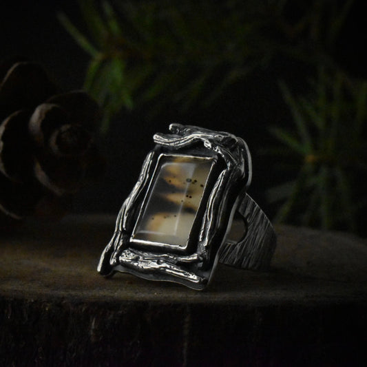 A handmade sterling silver statement ring with a large setting of picturesque montana agate. 