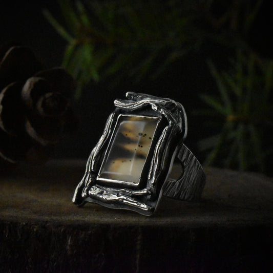 A handmade sterling silver statement ring with a large setting of picturesque montana agate.