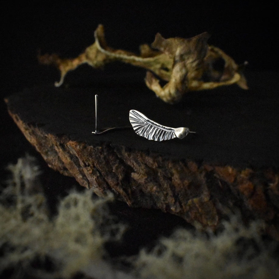 Another look at the Vine Maple Helicopter Stud Earrings, showing their sterling silver ear wires.