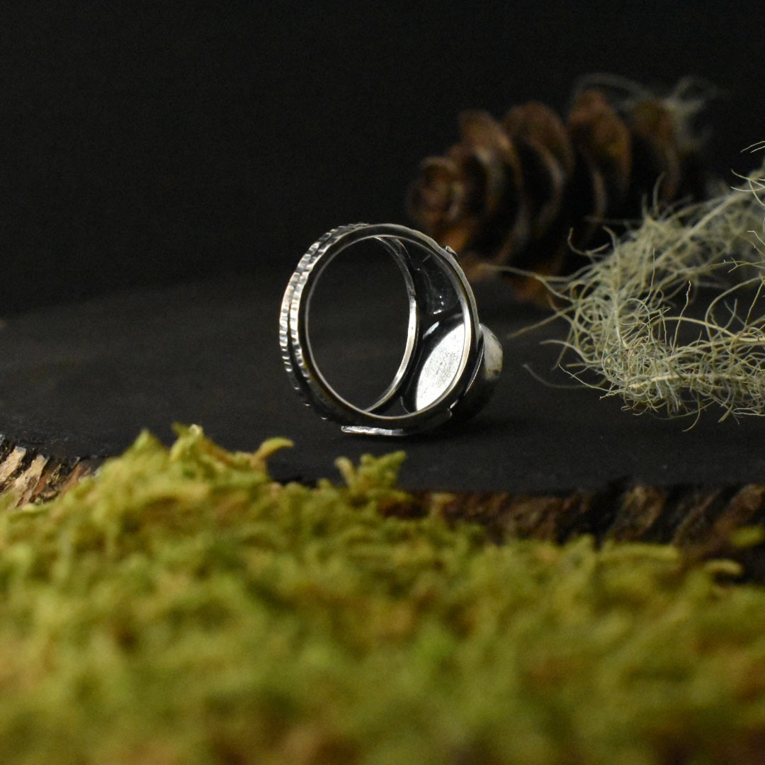 The underside of the Real Lichen Double Leaf Split Band Ring, showing its size 7 3/4 textured sterling silver double ring band. 