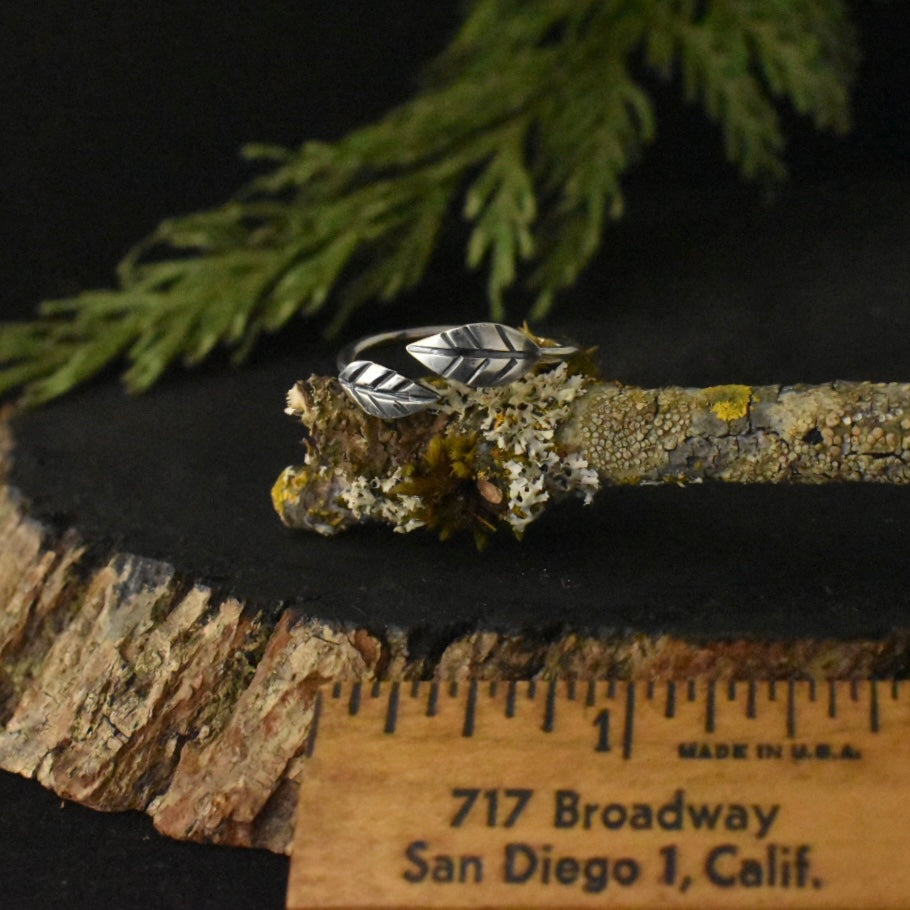 The Adjustable Double Leaf Ring with a ruler for scale, measuring around 3/4 inches wide overall.