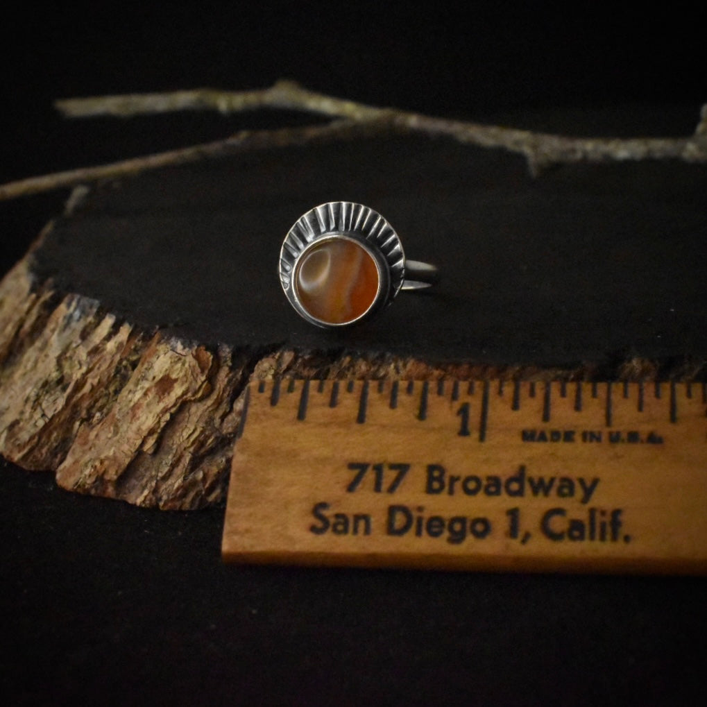 The Banded Agate Sunrise Ring with a ruler for scale, measuring around 1/2 inch wide.