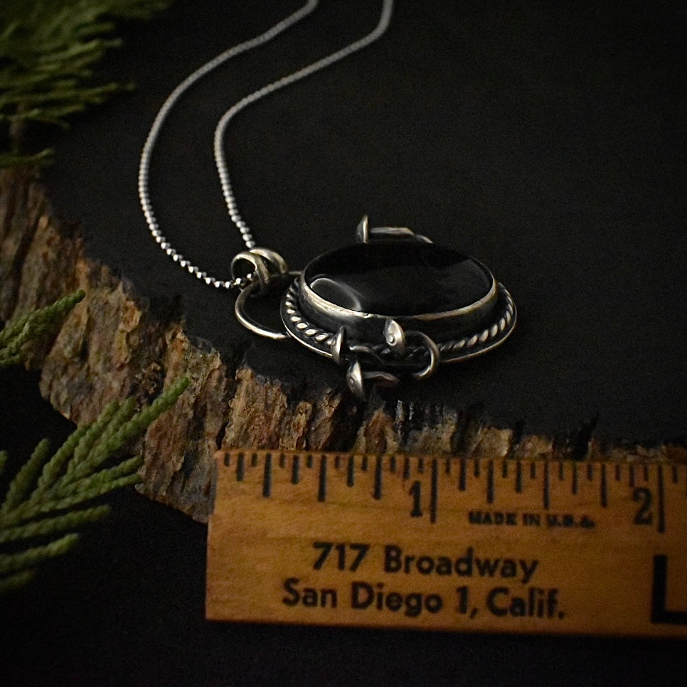 The Black Onyx Classic Fungal Pendant with a ruler for scale, measuring around 1 3/8 inches long.