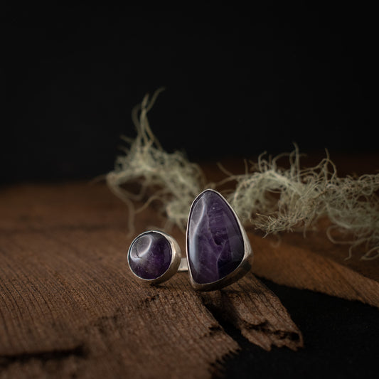 A handmade sterling silver statement ring, with two large settings of brilliant dark purple amethyst lace agate.