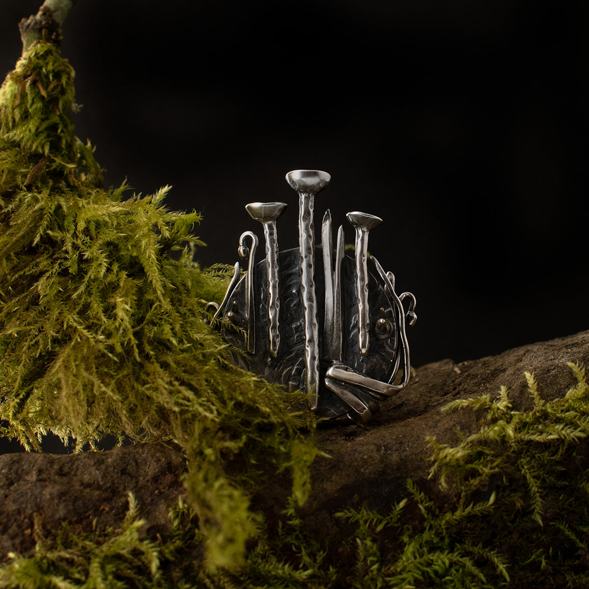 The back of the Lichen Love Brooch shows all the tiny details textured underneath its setting, and its variety of  specimens, sculpted by hand from sterling silver.