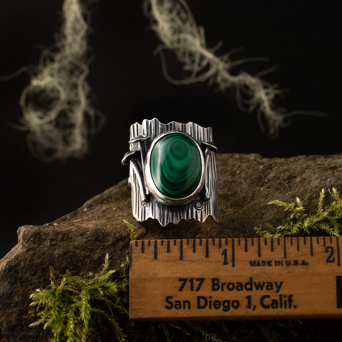 The Malachite Tree Trunk Ring with a ruler for scale, measuring around 1 inch wide overall.
