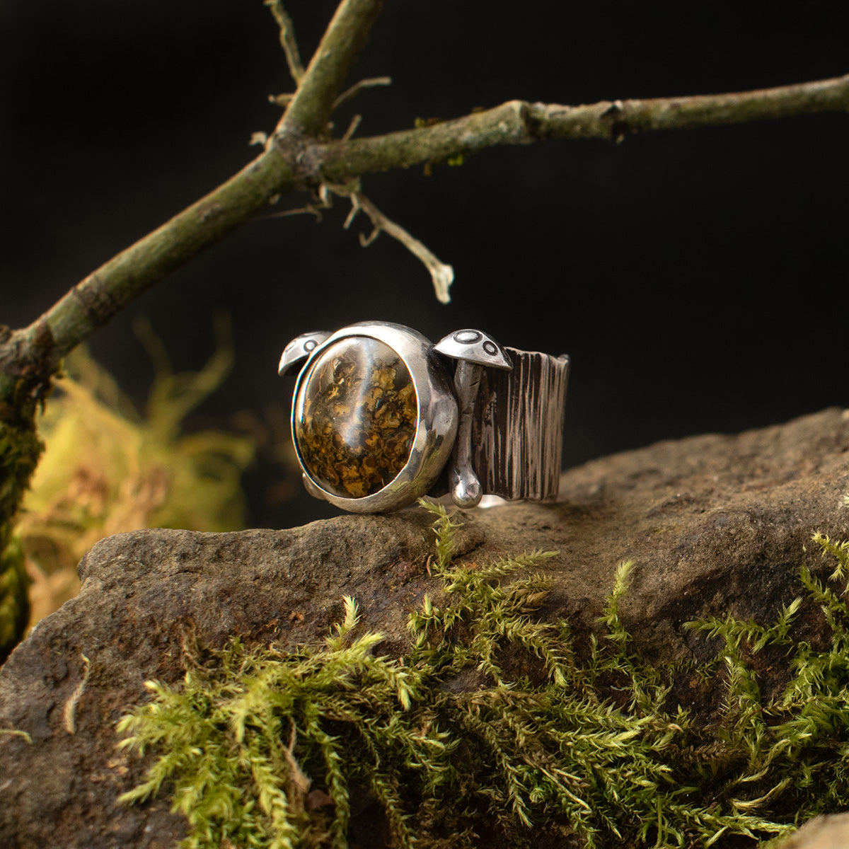 A three-quarter view of the Real Lichen Double Toadstool Ring shows its miniature Amanita mushrooms, each sculpted by hand from sterling silver.