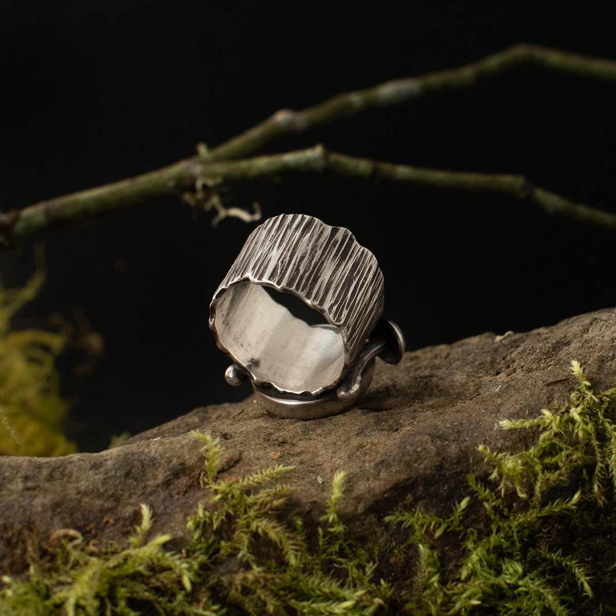 The underside of the Real Lichen Double Toadstool Ring shows its wide size 5 1/2 sterling silver ring band, textured to look like tree bark.